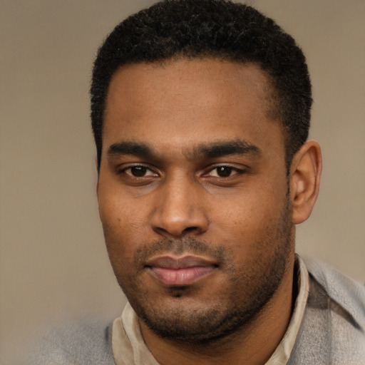 Joyful black young-adult male with short  black hair and brown eyes