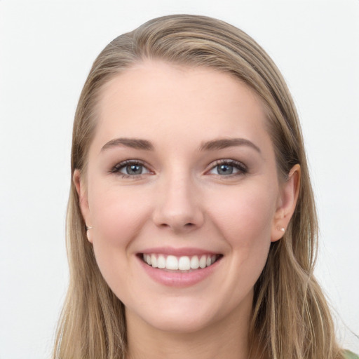 Joyful white young-adult female with long  brown hair and blue eyes