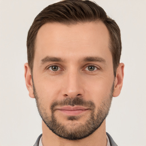 Joyful white young-adult male with short  brown hair and brown eyes