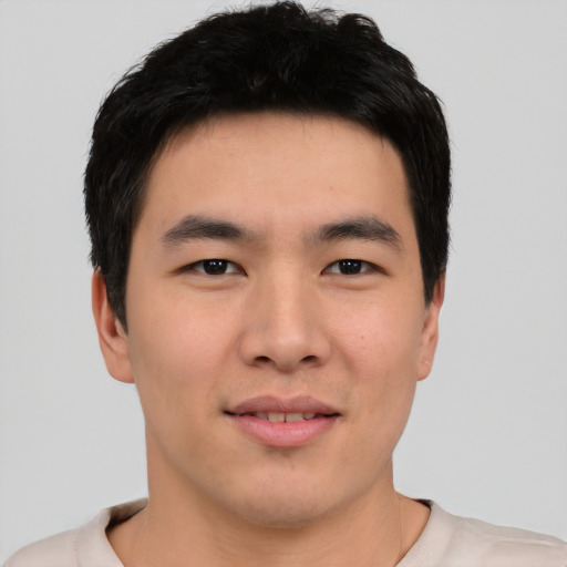 Joyful asian young-adult male with short  black hair and brown eyes