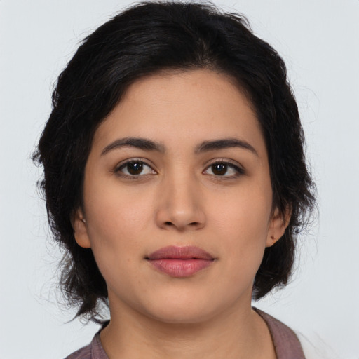 Joyful latino young-adult female with long  black hair and brown eyes