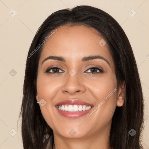 Joyful latino young-adult female with long  brown hair and brown eyes