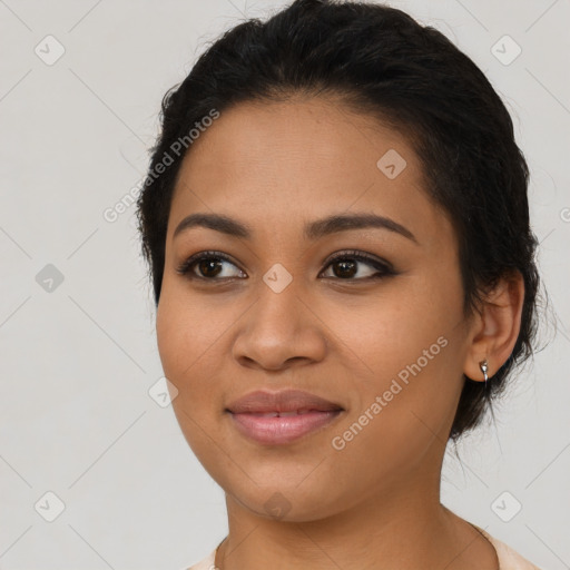 Joyful latino young-adult female with short  black hair and brown eyes