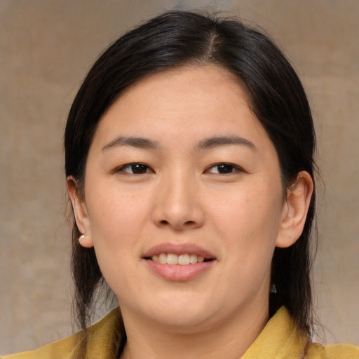 Joyful asian young-adult female with medium  brown hair and brown eyes