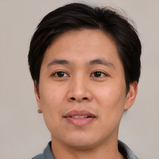 Joyful asian young-adult male with short  brown hair and brown eyes