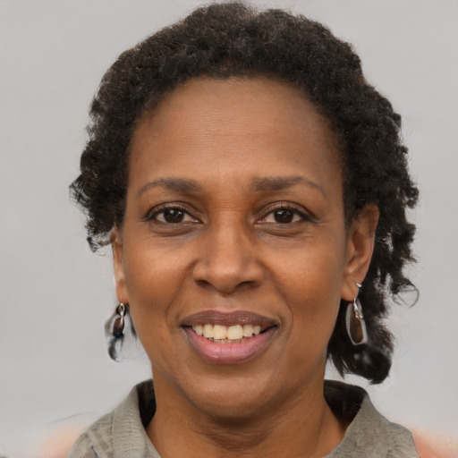 Joyful black adult female with short  brown hair and brown eyes