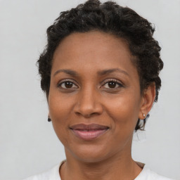 Joyful black adult female with short  brown hair and brown eyes