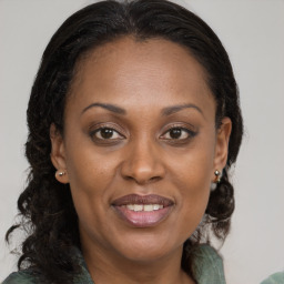 Joyful black adult female with medium  brown hair and brown eyes