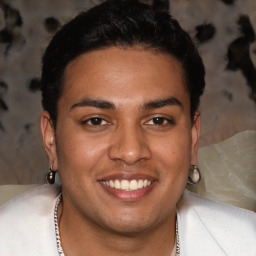 Joyful latino young-adult male with short  brown hair and brown eyes