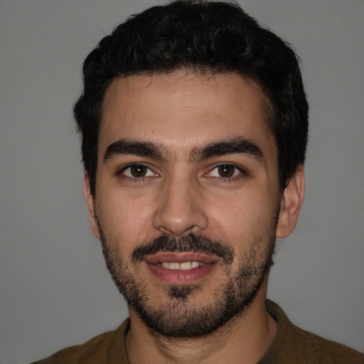 Joyful white young-adult male with short  black hair and brown eyes