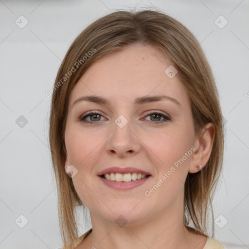 Joyful white young-adult female with medium  brown hair and grey eyes