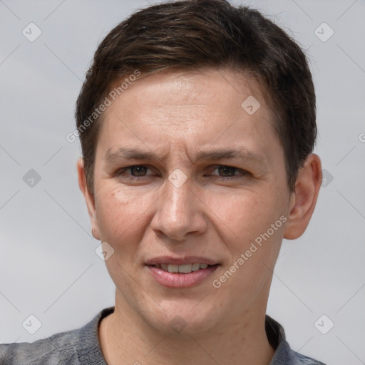 Joyful white adult male with short  brown hair and grey eyes