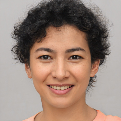 Joyful asian young-adult female with short  brown hair and brown eyes