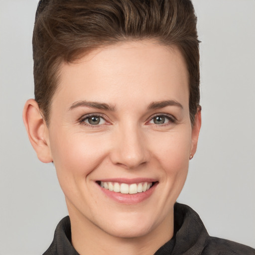 Joyful white young-adult female with short  brown hair and grey eyes