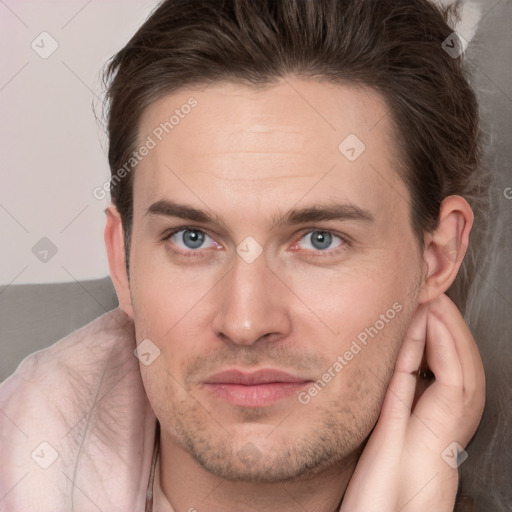 Joyful white young-adult male with short  brown hair and grey eyes