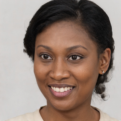 Joyful black young-adult female with medium  brown hair and brown eyes