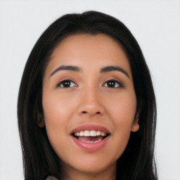 Joyful latino young-adult female with long  black hair and brown eyes