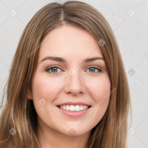 Joyful white young-adult female with long  brown hair and green eyes