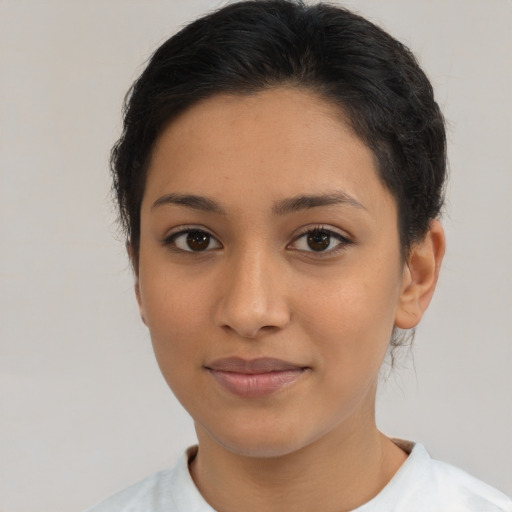 Joyful latino young-adult female with short  brown hair and brown eyes