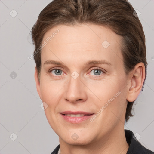 Joyful white adult female with medium  brown hair and grey eyes