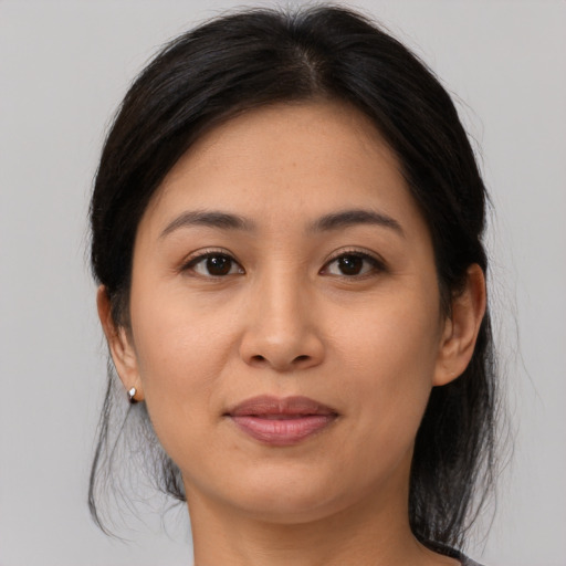 Joyful asian young-adult female with medium  brown hair and brown eyes
