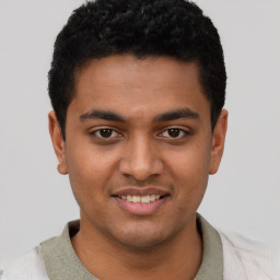 Joyful latino young-adult male with short  brown hair and brown eyes