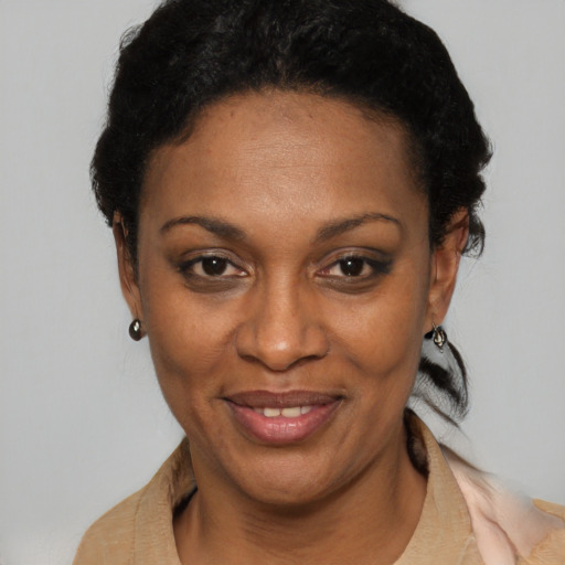 Joyful black adult female with short  black hair and brown eyes