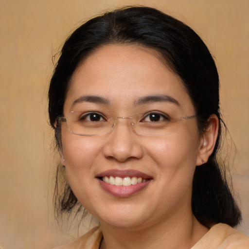 Joyful asian adult female with medium  brown hair and brown eyes