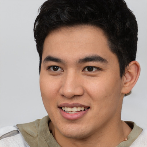 Joyful latino young-adult male with short  brown hair and brown eyes