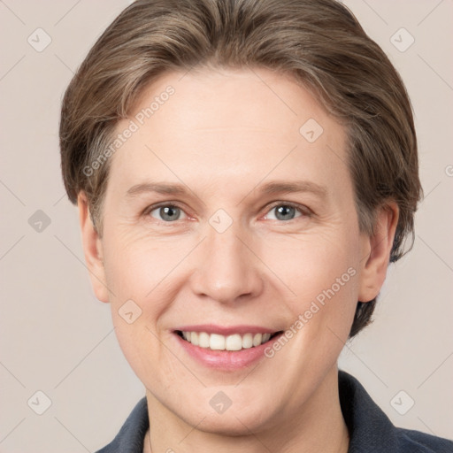 Joyful white adult female with short  brown hair and grey eyes