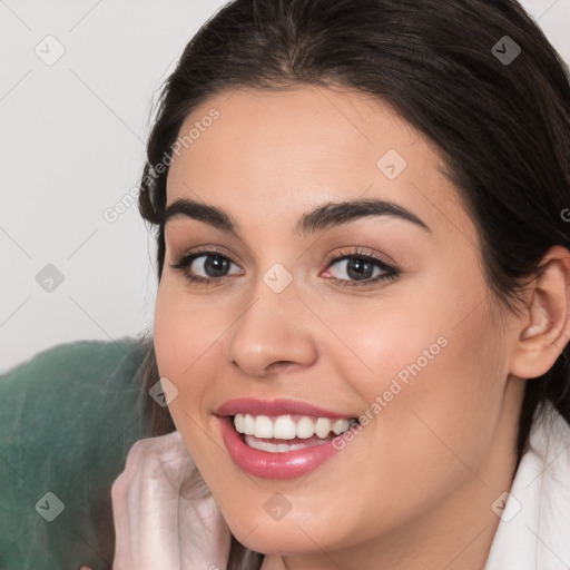 Joyful white young-adult female with long  brown hair and brown eyes