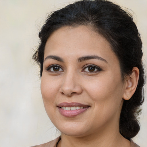 Joyful latino young-adult female with medium  brown hair and brown eyes