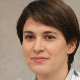 Joyful white adult female with medium  brown hair and brown eyes