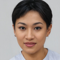 Joyful asian young-adult female with short  black hair and brown eyes