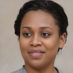 Joyful black young-adult female with medium  brown hair and brown eyes