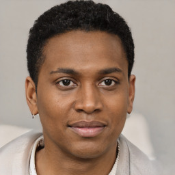 Joyful black young-adult male with short  brown hair and brown eyes