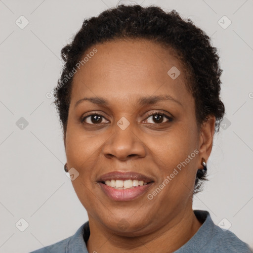 Joyful black adult female with short  brown hair and brown eyes