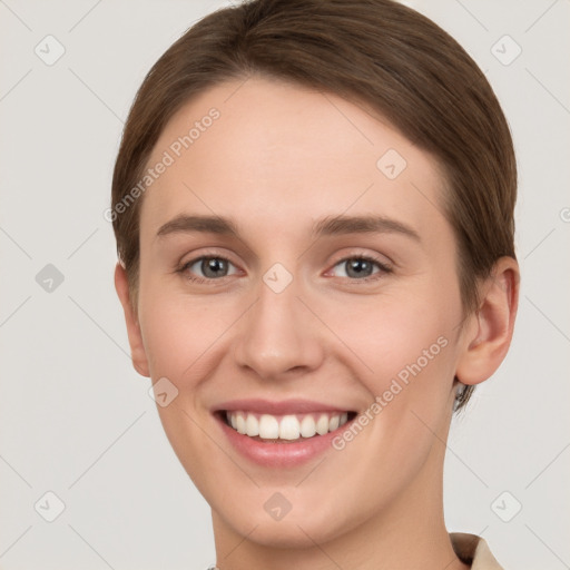 Joyful white young-adult female with short  brown hair and grey eyes