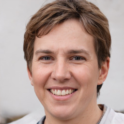 Joyful white young-adult female with short  brown hair and grey eyes