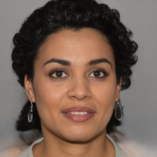 Joyful latino young-adult female with short  brown hair and brown eyes