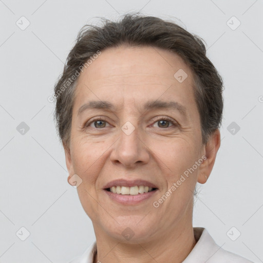 Joyful white adult female with short  brown hair and brown eyes