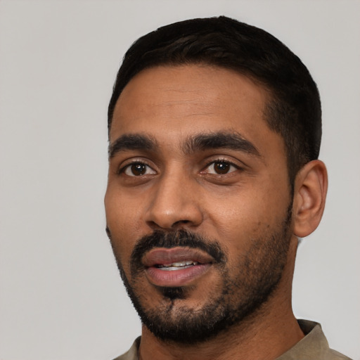 Joyful black young-adult male with short  black hair and brown eyes