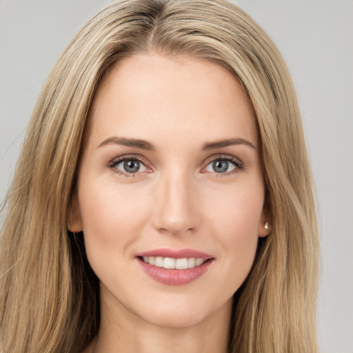 Joyful white young-adult female with long  brown hair and green eyes