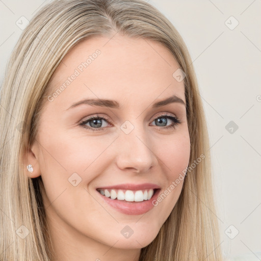 Joyful white young-adult female with long  brown hair and blue eyes