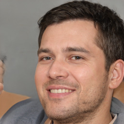 Joyful white adult male with short  brown hair and brown eyes