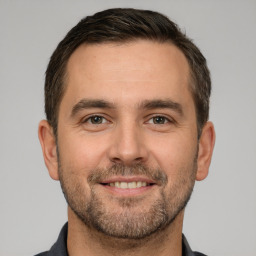 Joyful white adult male with short  brown hair and brown eyes