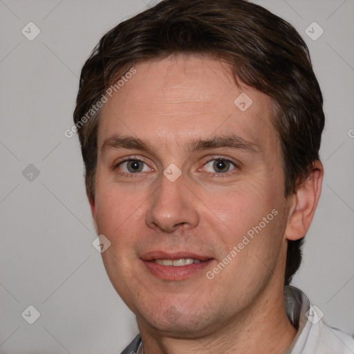 Joyful white adult male with short  brown hair and brown eyes