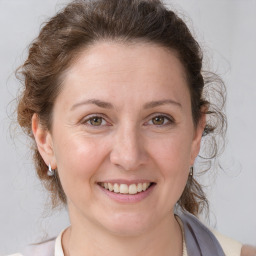 Joyful white adult female with medium  brown hair and brown eyes