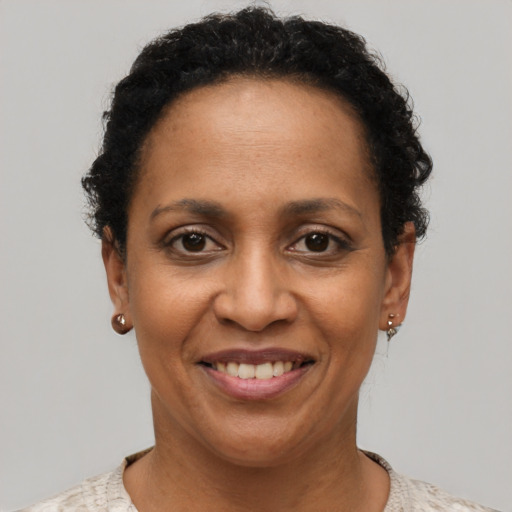 Joyful black adult female with short  black hair and brown eyes