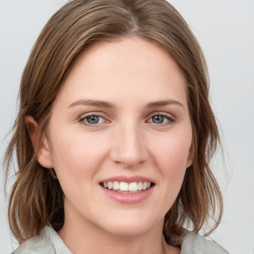 Joyful white young-adult female with medium  brown hair and blue eyes